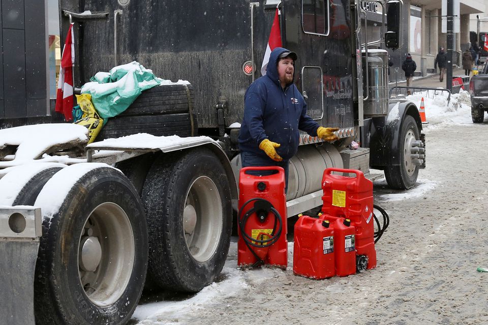 A person stands beside jerry gas cans, as truckers and supporters continue to protest coronavirus disease (COVID-19) vaccine mandates, in Ottawa, Ontario, Canada, February 6, 2022. Photo: Reuters