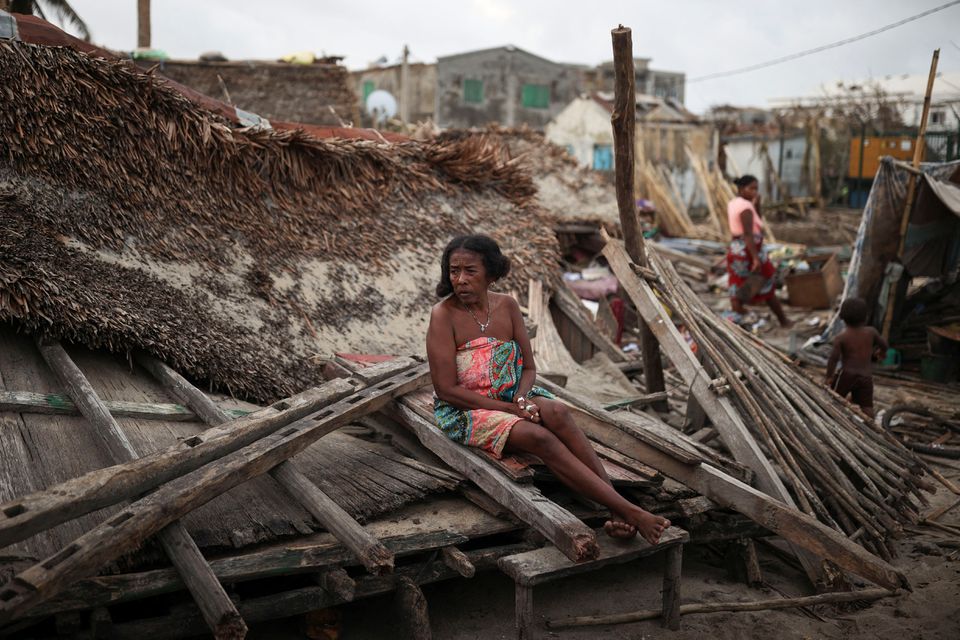 A woman sits on the debris of her destroyed house, in the aftermath of Cyclone Batsirai, in the town of Mananjary, Madagascar, February 7, 2022. Photo: Reuters