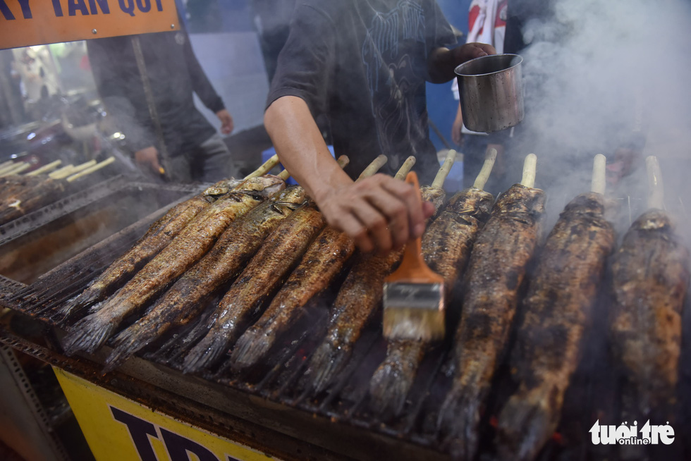 Snakehead fish are grilled at a shop in Tan Phu District, Ho Chi Minh City, February 9, 2022, to prepare for the God of Wealth Day. Photo: Ngoc Phuong / Tuoi Tre