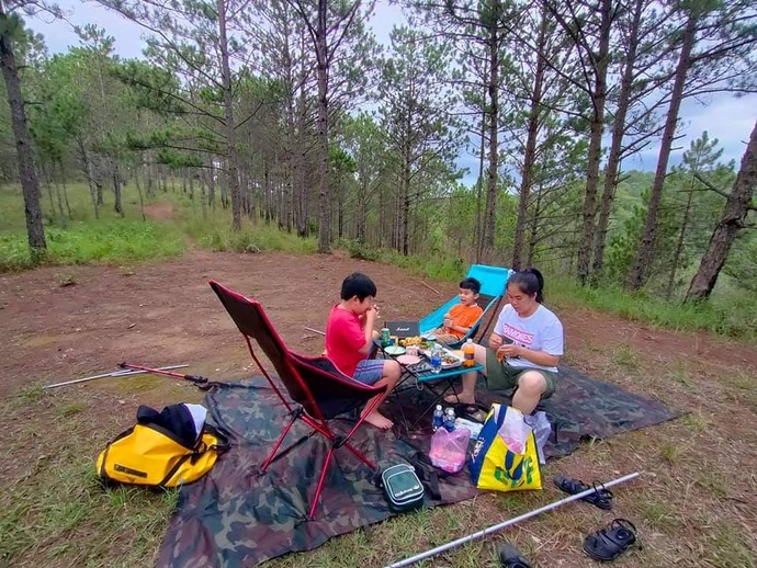 Nguyen Quoc Thang and his family have lunch during a camping trip. Photo: Q.T / Tuoi Tre