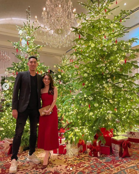 Justin Young and his girlfriend pose for a photo with Christmas trees. Photo: VBA