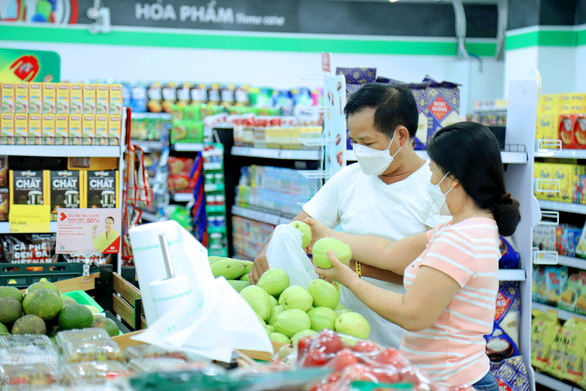 People shop for groceries at a WinMart+ store.