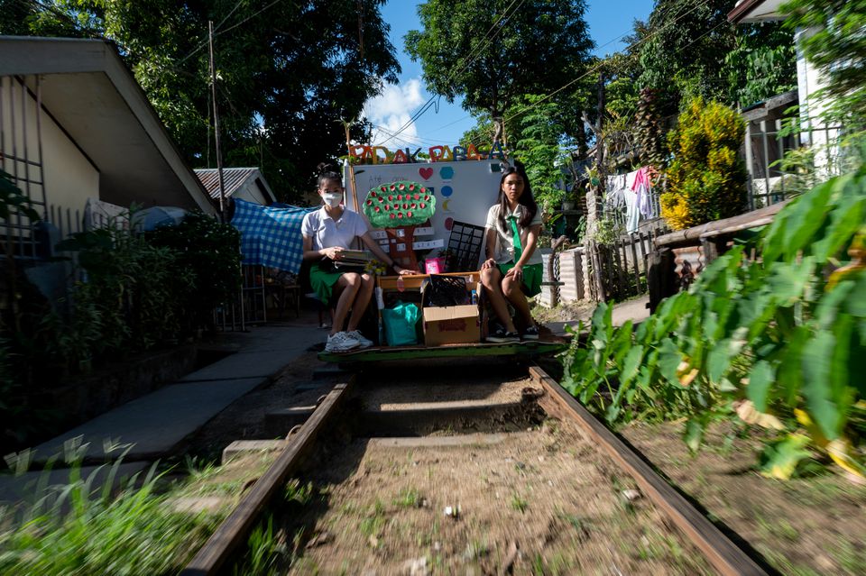 Student volunteers ride on their makeshift trolley which serves as a mobile library for children, in Tagkawayan, Quezon Province, Philippines, February 15, 2022. Photo: Reuters