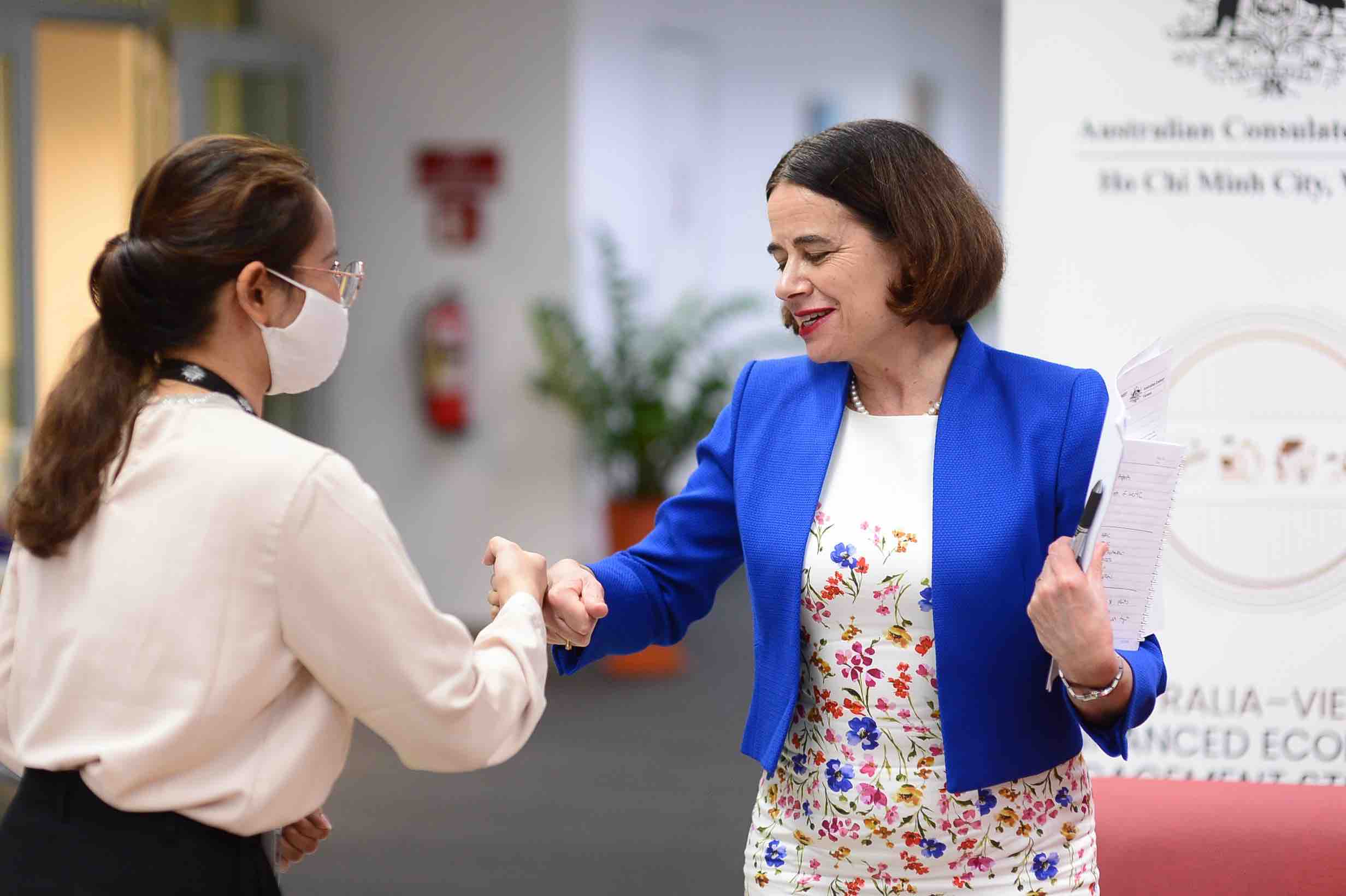A reporter of Tuoi Tre (Youth) newspaper (left) and Australian Ambassador to Vietnam Robyn Mudie (right) perform a fist bump during an exclusive interview with Tuoi Tre News in Ho Chi Minh City, Vietnam, February 21, 2022. Photo: Quang Dinh / Tuoi Tre
