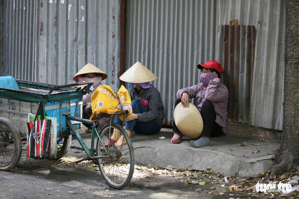 This photo shows three women taking a rest on a street side in Ho Chi Minh City in the hot sun. Photo: Le Phan / Tuoi Tre