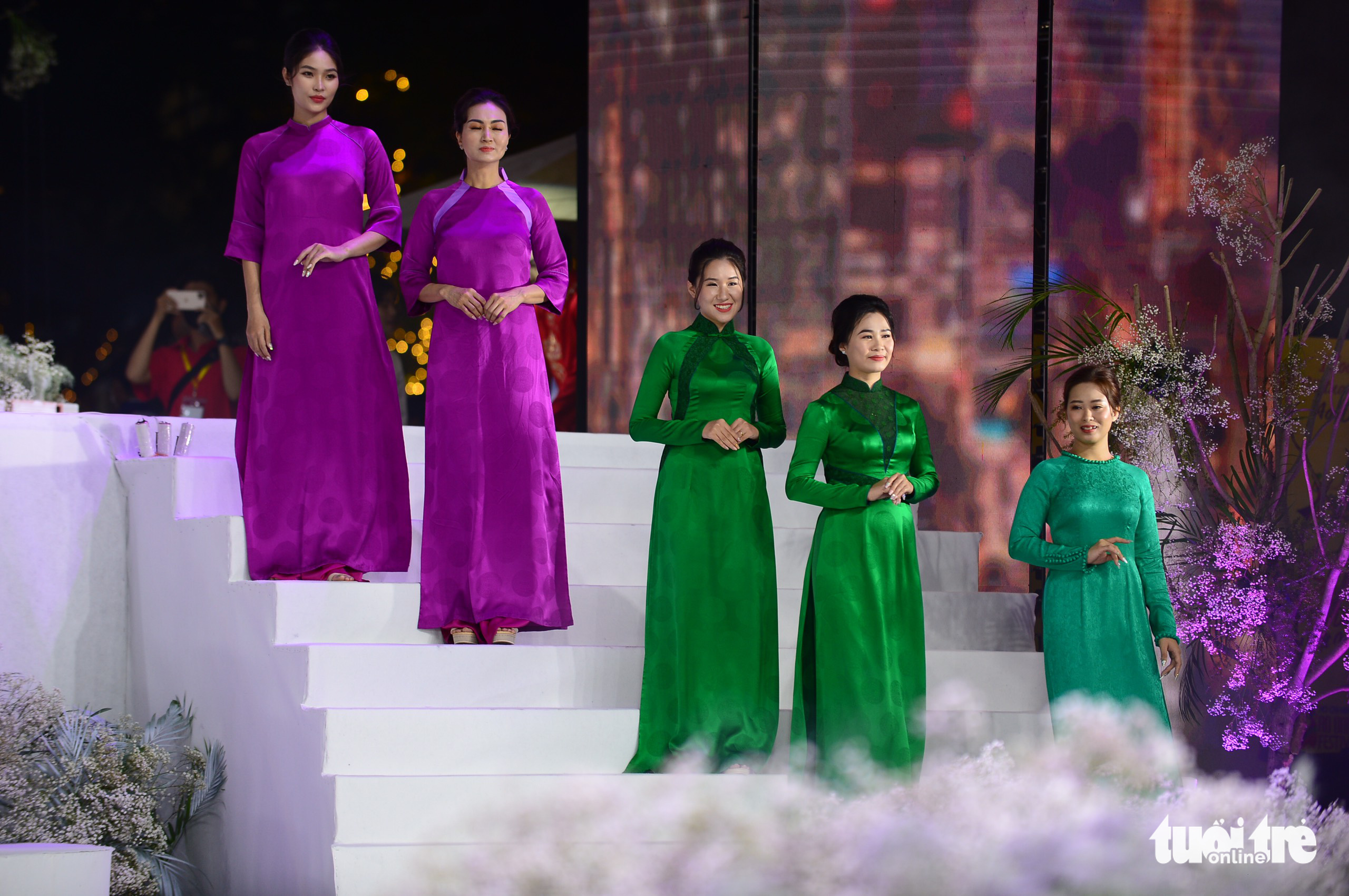 Health workers present the ao dai in the collection of Anna Hanh during the opening ceremony of the Ho Chi Minh City Ao Dai Festival, March 5, 2022. Photo: Quang Dinh / Tuoi Tre