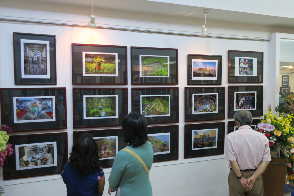 Visitors enjoy photos of Vietnam through the lens of female photographers from the Ho Chi Minh City Photographers Association.
