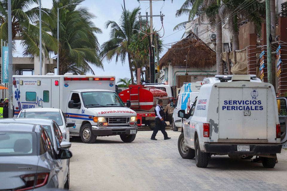 A police officer walks past an ambulance and the coroner's vehicle at a scene where an explosion occurred at the Kool Beach restaurant, presumably caused by gas accumulation, which left four tourists injured, according to local media, in Playa del Carmen, Mexico March 14, 2022. Photo: Reuters