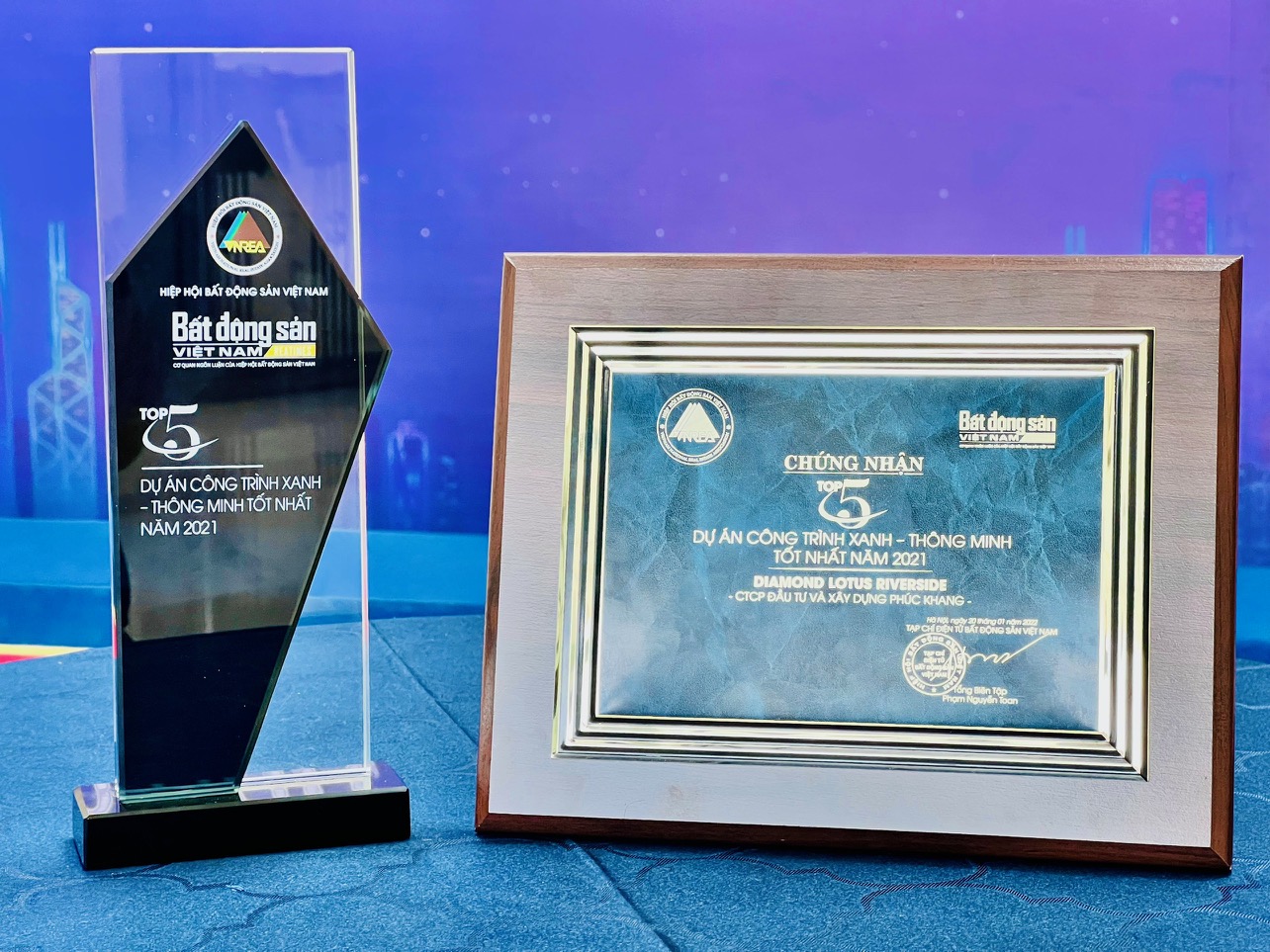 The trophy and certificate recognizing the Diamond Lotus Riverside project of Phuc Khang Corporation as one of the five best green-smart constructions in 2021