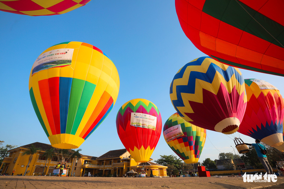 Hot-air balloons illuminate the sky above Hoi An's tourism
