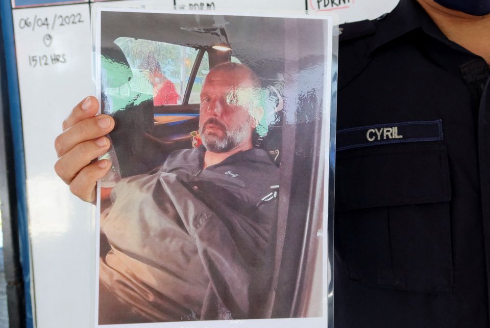 Mersing district police chief Cyril Edward shows a picture of British man Adrian Peter Chesters, who was found safe after drifting at sea for two and a half days, during a press conference at Mersing, Johor, Malaysia, April 9, 2022. Photo: Reuters