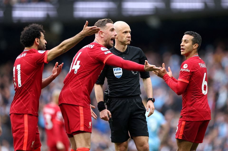 Soccer Football - Premier League - Manchester City v Liverpool - Etihad Stadium, Manchester, Britain - April 10, 2022 Liverpool's Mohamed Salah, Thiago Alcantara and Jordan Henderson appeal to referee Anthony Taylor Action Images via Reuters