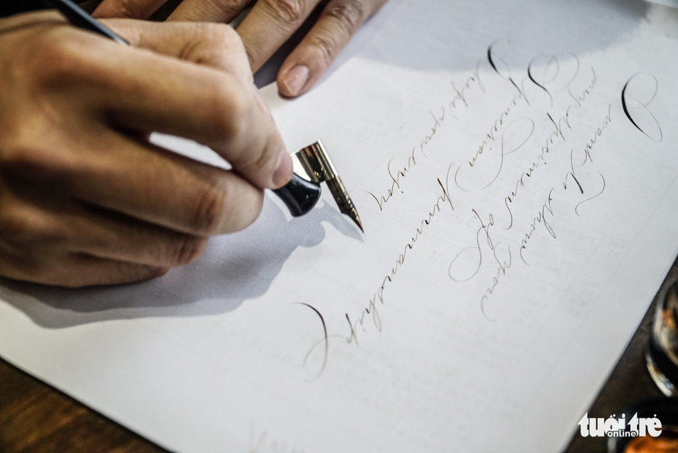 Dao Huy Hoang practice calligraphy handwritting at his workshop in Hanoi. Photo: Nguyen Hien / Tuoi Tre