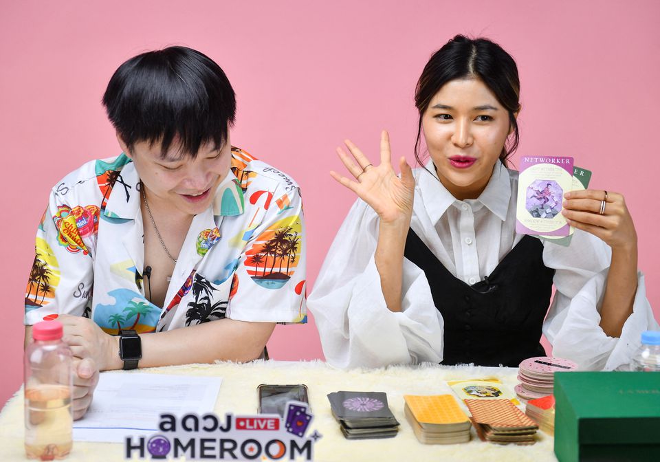 Fortune-tellers livestream a card reading session on an online platform, as many young Thais increasingly seek divination for quick answers, at their office in Bangkok, Thailand March 30, 2022. Photo: Reuters