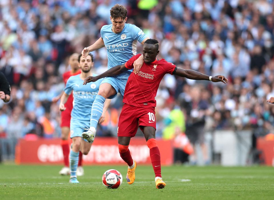 Soccer Football - FA Cup Semi Final - Manchester City v Liverpool - Wembley Stadium, London, Britain - April 16, 2022 Liverpool's Sadio Mane in action with Manchester City's John Stones. Photo: Action Images via Reuters