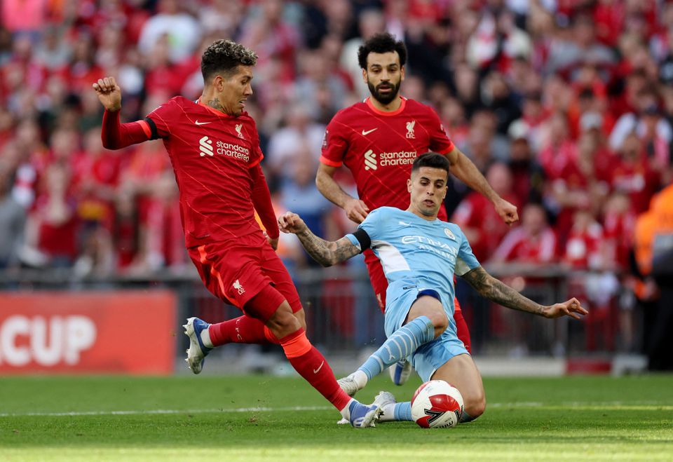 Soccer Football - FA Cup Semi Final - Manchester City v Liverpool - Wembley Stadium, London, Britain - April 16, 2022 Manchester City's Joao Cancelo in action with Liverpool's Roberto Firmino and Mohamed Salah. Photo: Action Images via Reuters