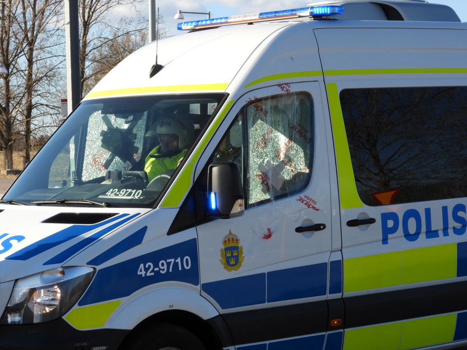 A police officer sits in a car with broken windows during a riot ahead of a demonstration planned by Danish anti-Muslim politician Rasmus Paludan and his Stram Kurs party, which was to include a burning of the Muslim holy book Koran, in Navestad, Norrkoping, Sweden April 17, 2022, in this handout image obtained by Reuters on April 17, 2022. Ulf Wigh/Wighsnews/Handout via Reuters