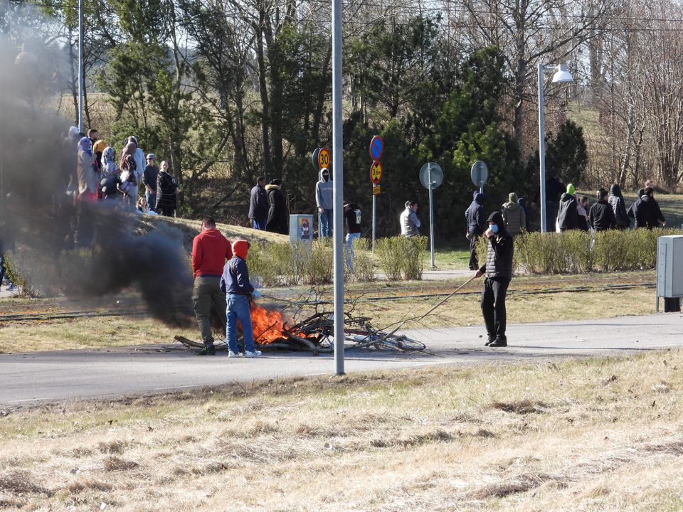 People burn branches to block a road during a riot ahead of a demonstration planned by Danish anti-Muslim politician Rasmus Paludan and his Stram Kurs party, which was to include a burning of the Muslim holy book Koran, in Navestad, Norrkoping, Sweden April 17, 2022, in this handout image obtained by Reuters on April 17, 2022. Ulf Wigh/Wighsnews/Handout via Reuters