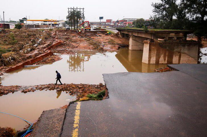 A man walks around a damaged bridge caused by flooding in Umlazi near Durban, South Africa, April 16, 2022. Photo: Reuters