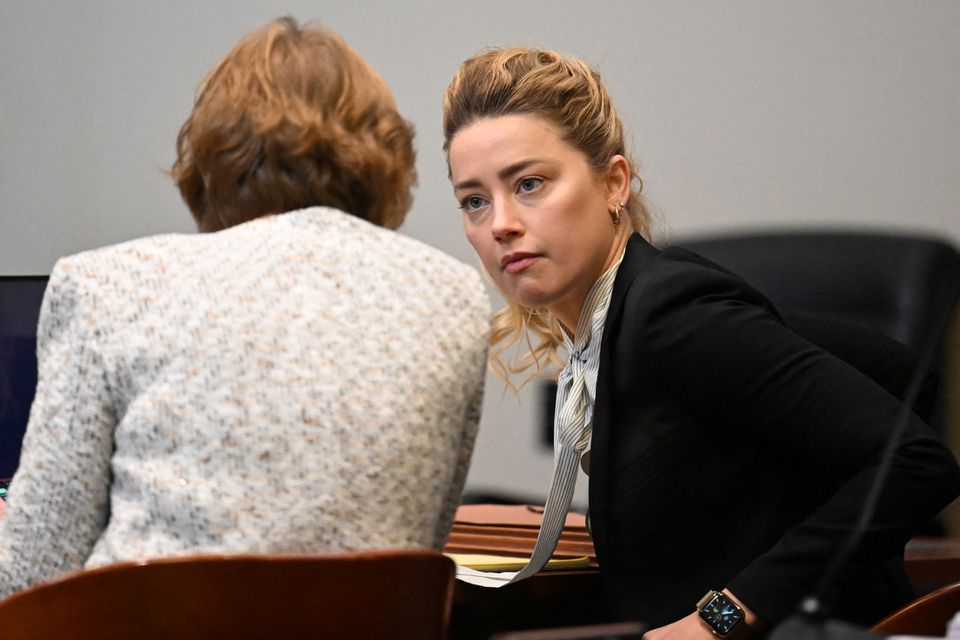 Actor Amber Heard speaks to her attorney at the Fairfax County Circuit Courthouse as the defamation case brought against her by her ex-husband Johnny Depp continues, in Fairfax, Virginia, U.S., April 19, 2022. Jim Watson/Pool via Reuters