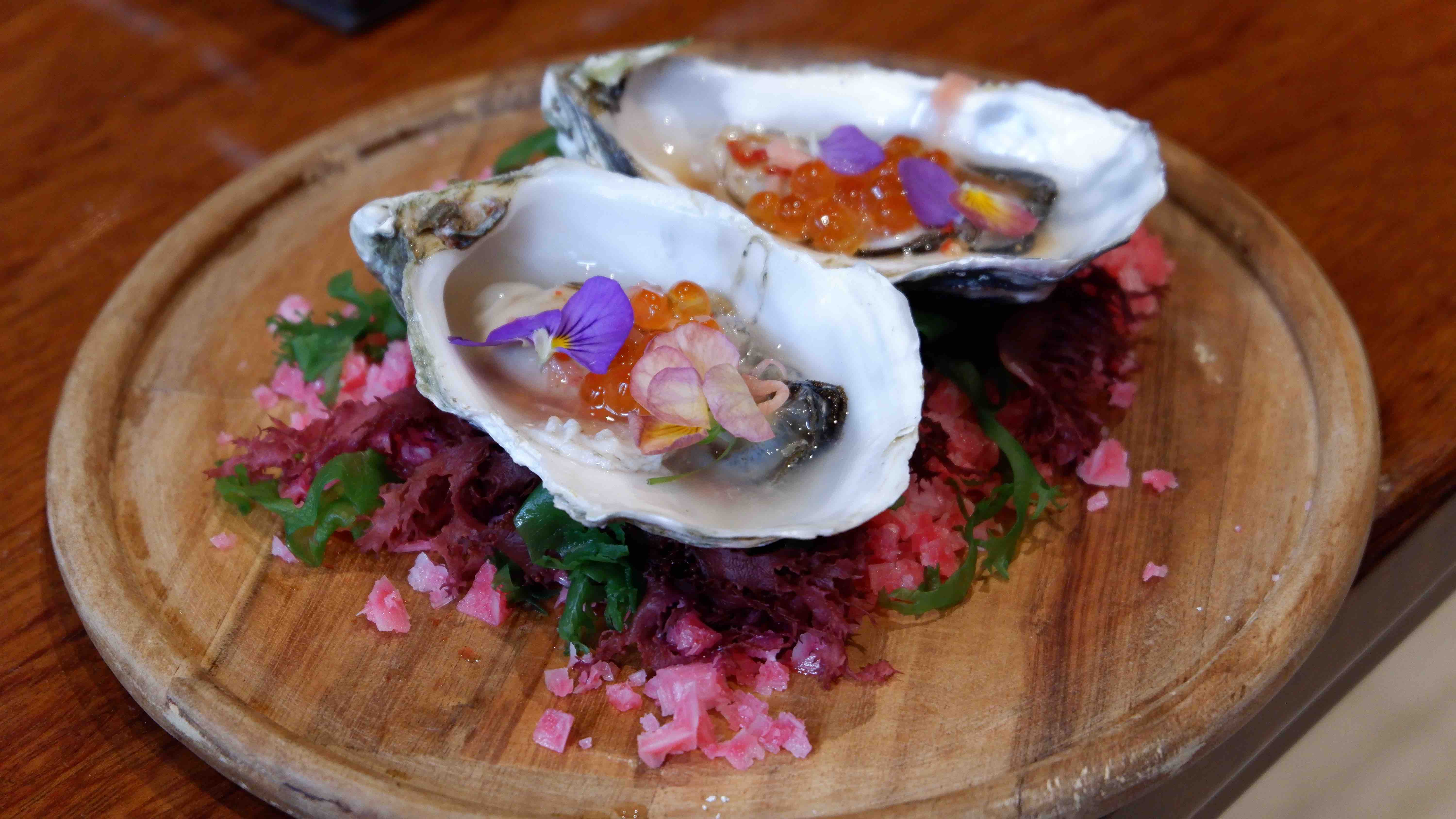 A dish of raw oysters top with salmon roe by chef Luke Nguyen. Photo: Linh To / Tuoi Tre