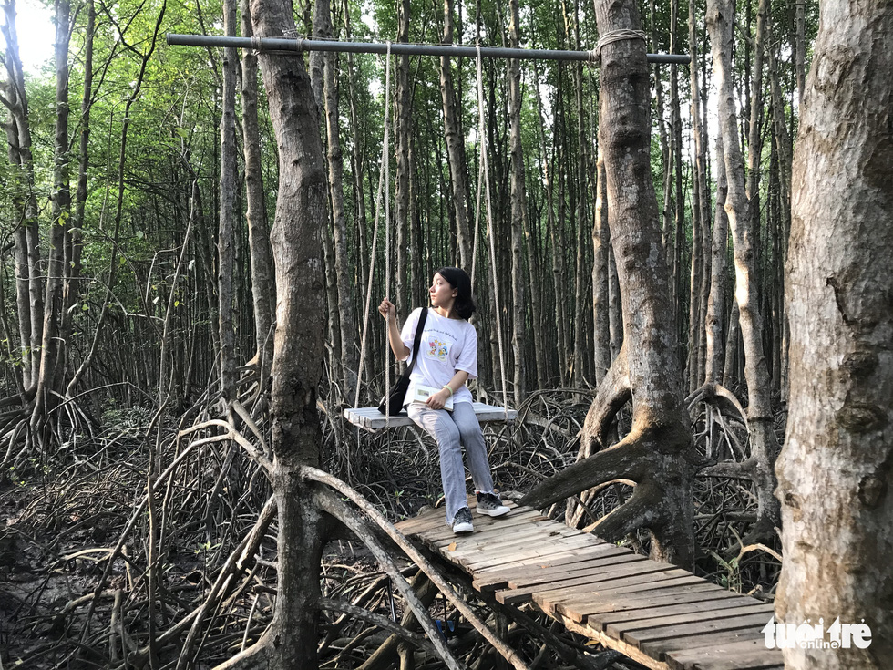 A visitor poses for a photo at the Can Gio Mangrove Forest in Can Gio Island District, Ho Chi Minh City. Photo: Vu Thuy / Tuoi Tre