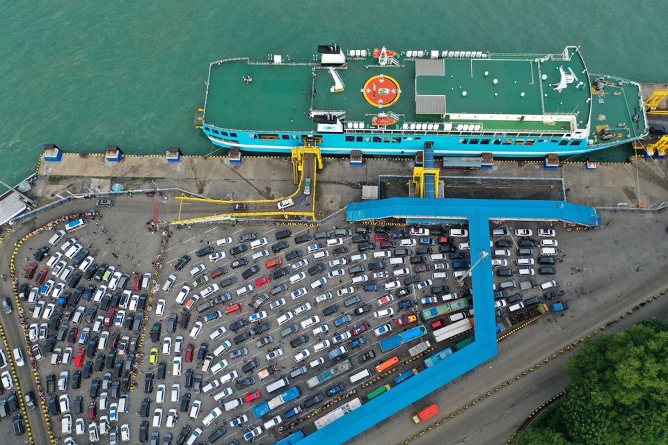 Cars queue to board the ship for Sumatra island as Indonesian Muslims travel home to celebrate Eid al-Fitr, known locally as 'Mudik', at Merak port in Cilegon, Banten, Indonesia, April 29, 2022, in this photo taken with a drone by Antara Foto. Antara Foto/Akbar Nugroho Gumay/via Reuters