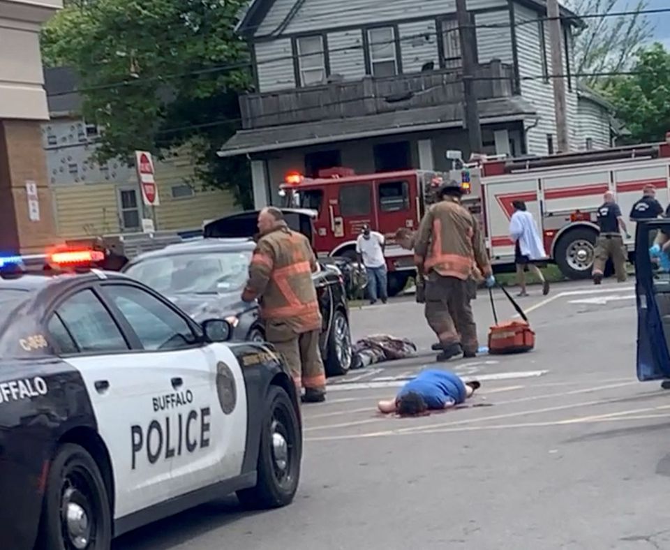SENSITIVE MATERIAL. THIS IMAGE MAY OFFEND OR DISTURB Injured people lie on the ground following a mass shooting in the parking lot of TOPS supermarket, in this still image from a social media video in Buffalo, New York, U.S. May 14, 2022. Courtesy of BigDawg/ via REUTERS
