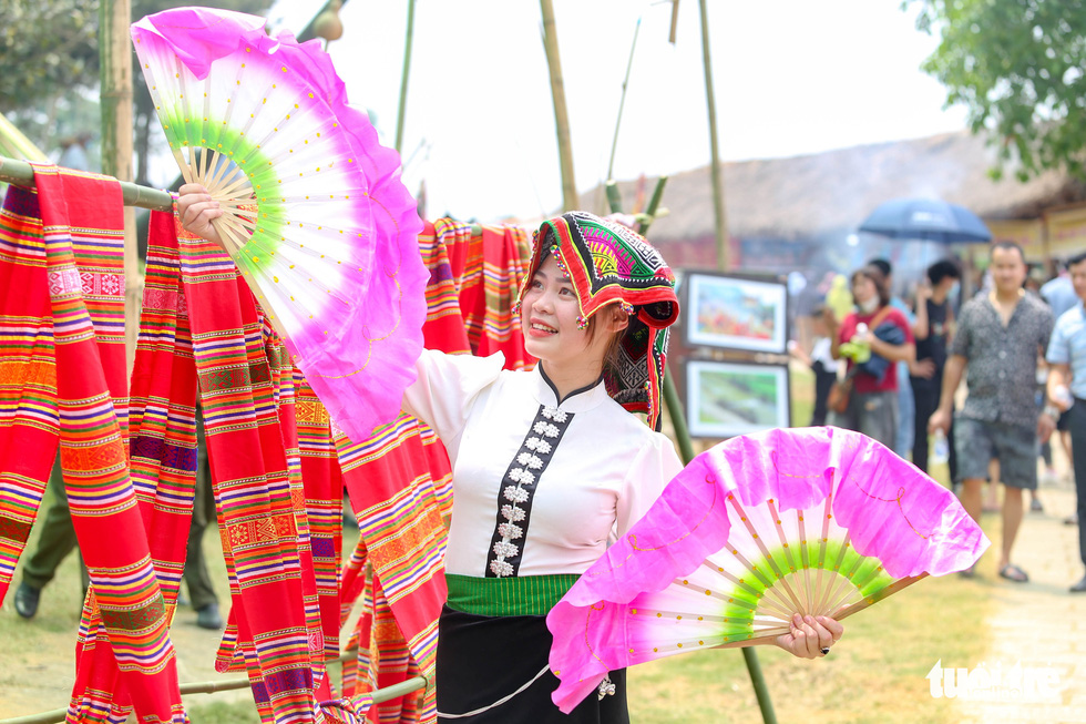 An ethnic young woman poses for a photo at the Culture-Tourism Village for Vietnamese Ethnic Groups in Son Tay District, Hanoi. Photo: Ha Quan / Tuoi Tre
