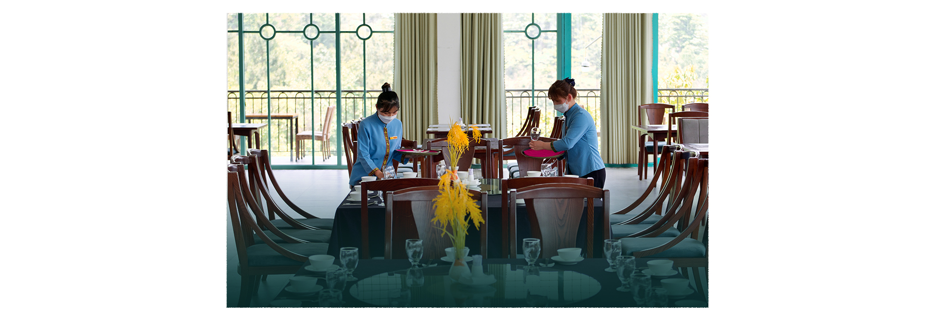 Waitresses prepare a table in the dining hall at Le Champ Tu Le Resort Hot Spring & Spa in Van Chan District, Yen Bai Province, Vietnam. Photo: Nam Tran / Tuoi Tre