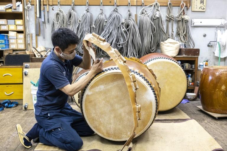 This photo taken on April 26, 2022 shows a craftsperson working on the renovation of a Japanese taiko drum at the Miyamoto Unosuke workshop in Tokyo. Photo: AFP