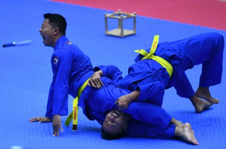 Indonesia's team competes in the men's multiple weapon practice category of vovinam. Photo: AFP