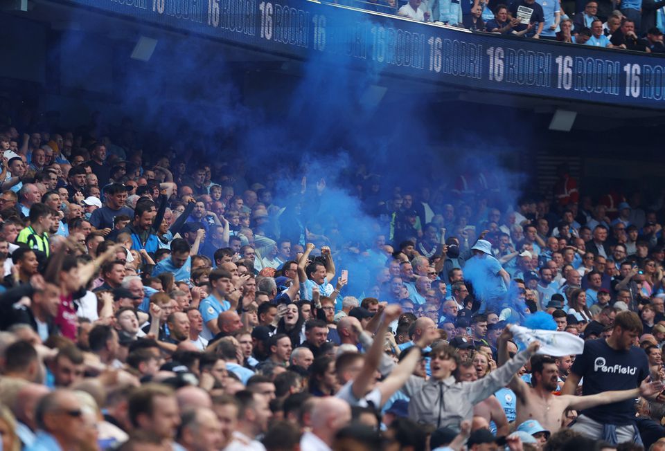 Soccer Football - Premier League - Manchester City v Aston Villa - Etihad Stadium, Manchester, Britain - May 22, 2022 Manchester City fans celebrate with flares after Rodri scores their second goal. Photo: Reuters