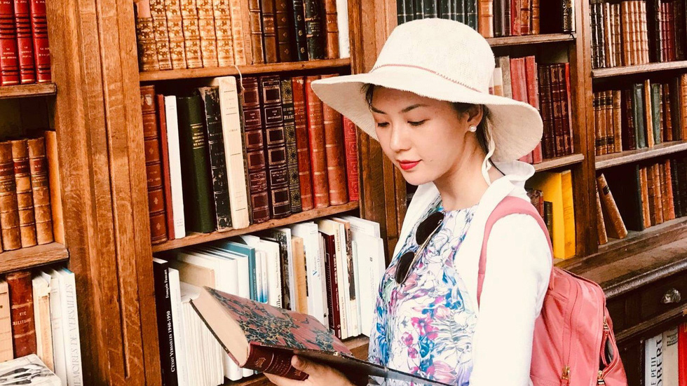 According to Thanh Nha, reading is immensely beneficial. She is seen with her book collection in this supplied photo.