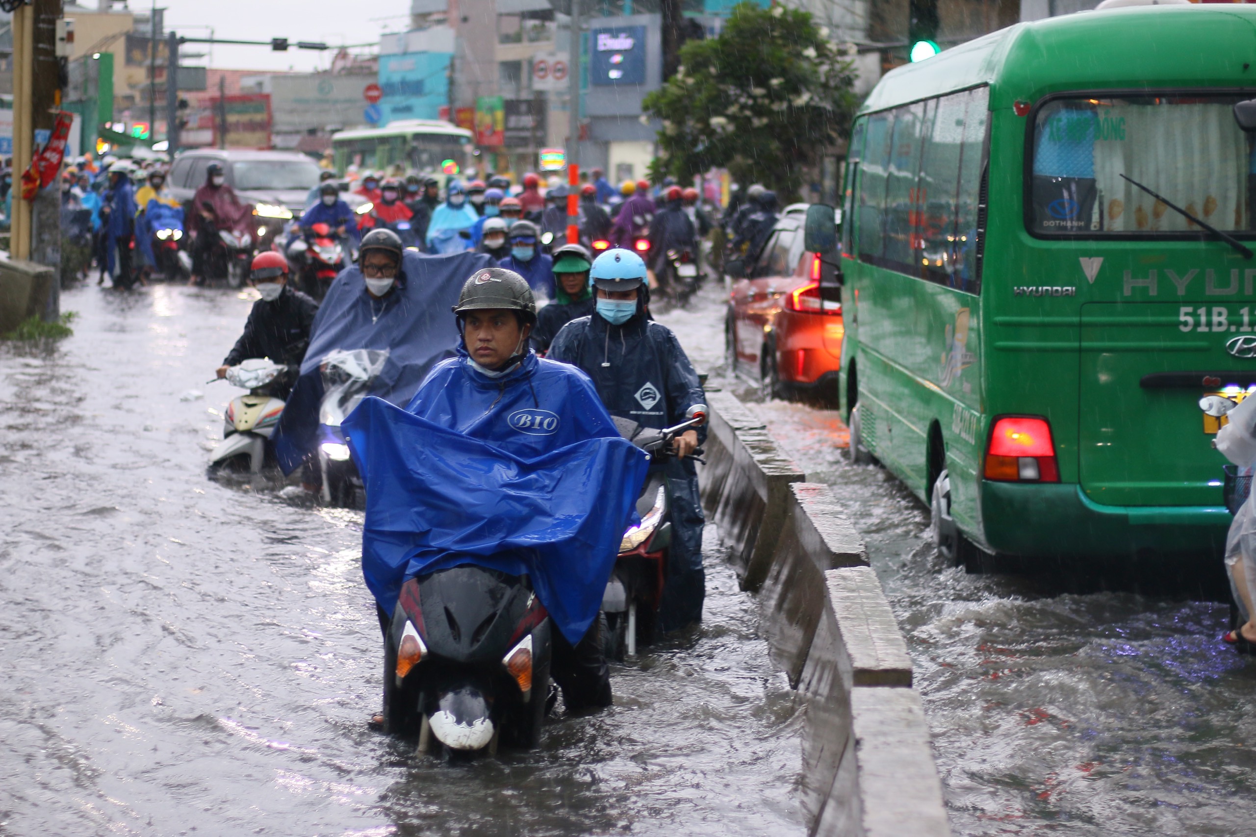 People commute on flooded To Ngoc Van Street in Thu Duc City, Ho Chi Minh City, June 2, 2022. Photo: Chau Tuan / Tuoi Tre