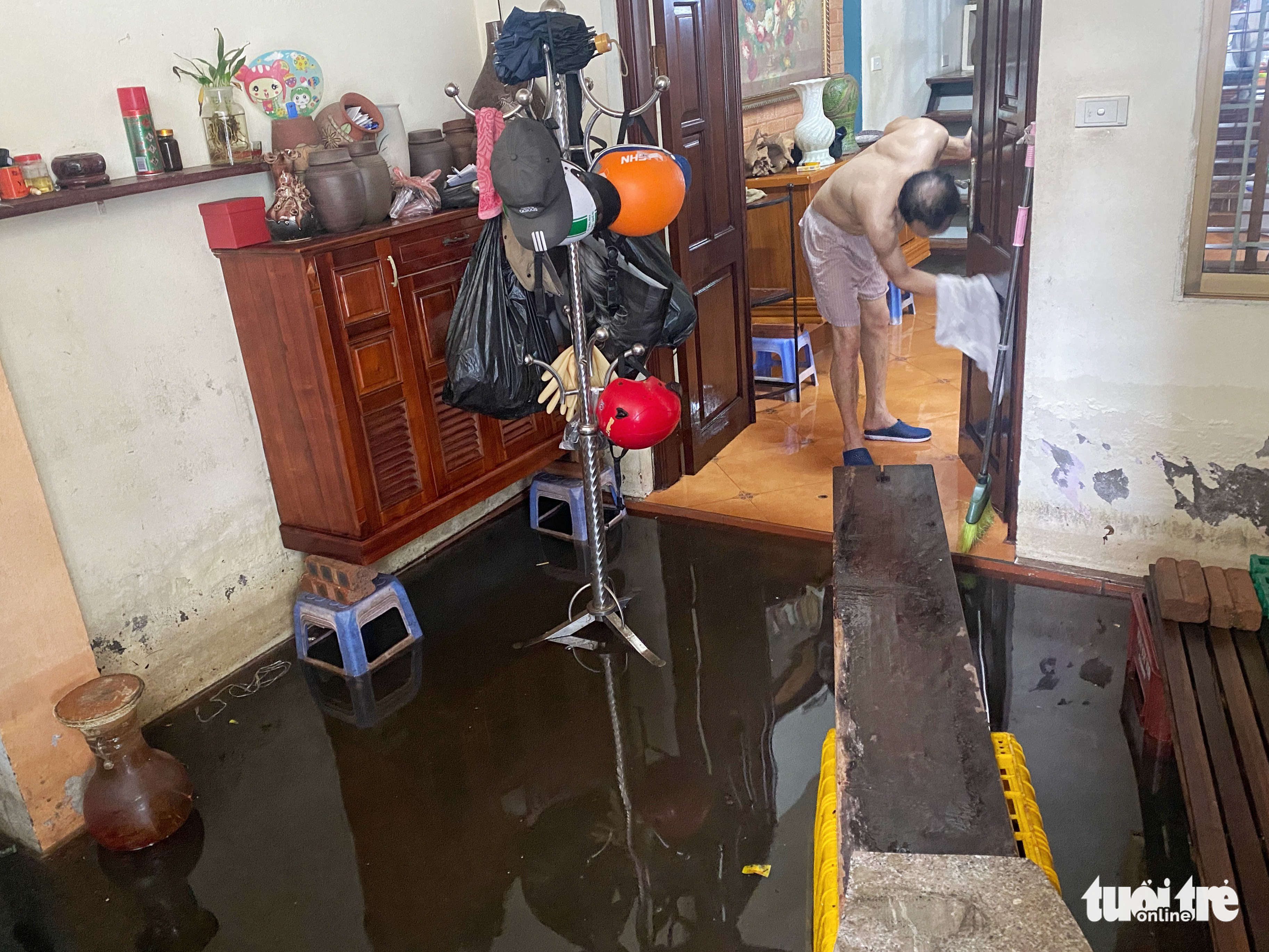 A house is submerged in dark floodwater in Tay Ho District, Hanoi. Photo: Pham Tuan / Tuoi Tre