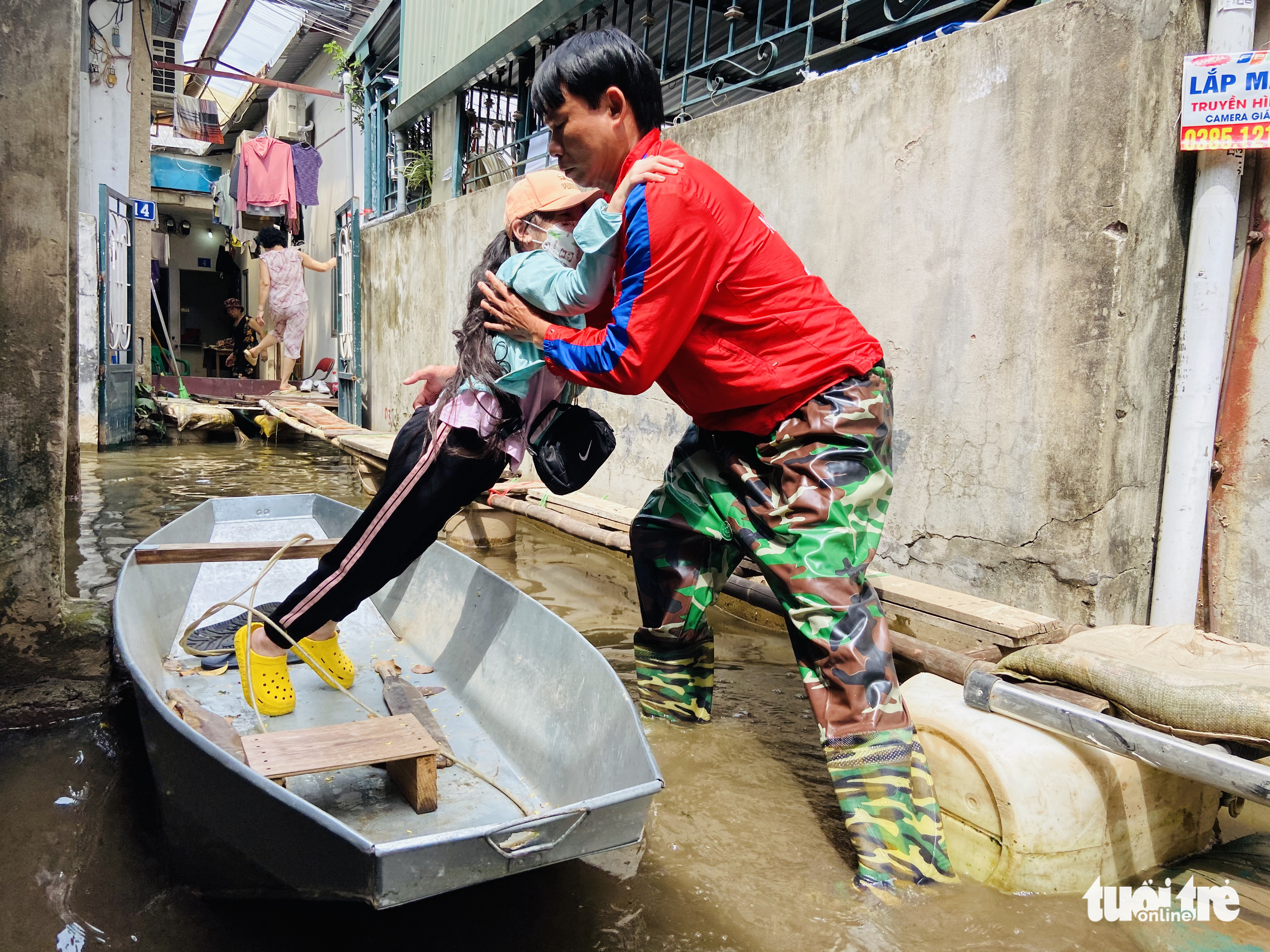 A man uses a boat to take his daughter to school in Tu Lien Ward, Tay Ho District, Hanoi. Photo: Quang The / Tuoi Tre