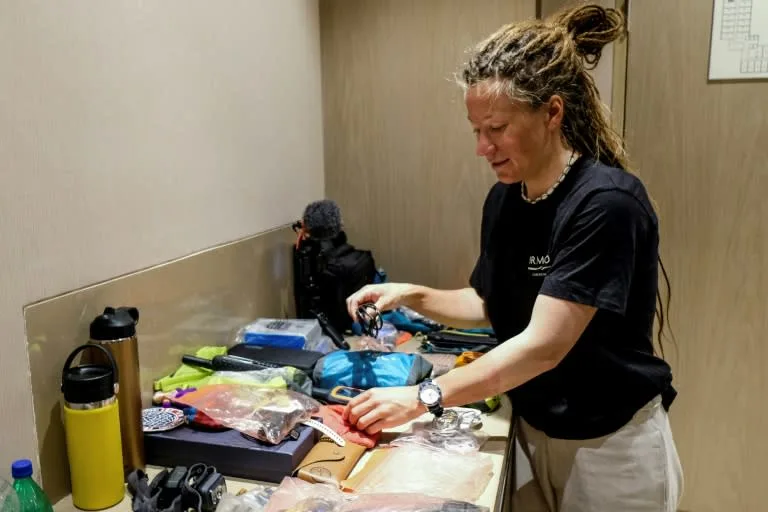 Norwegian mountaineer Kristin Harila arranges her equipment after an interview with AFP in Kathmandu. BIKASH KARKI AFP