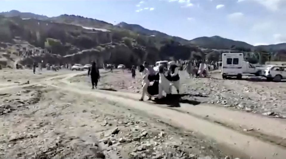 People carry injured to be evacuated following a massive earthquake, in Paktika Province, Afghanistan, June 22, 2022, in this screen grab taken from a video. Photo: BAKHTAR NEWS AGENCY/Handout via REUTERS