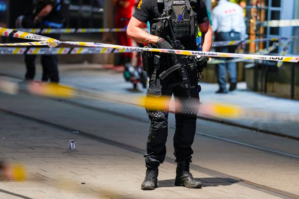 A member of the security forces stands at the site where several people were injured during a shooting outside the London pub in central Oslo, Norway June 25, 2022. Javad Parsa/NTB/via Reuters