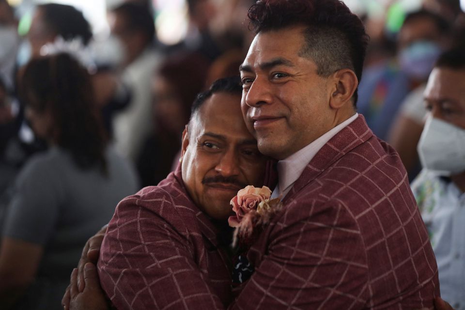 A couple embraces as they celebrate LGBTQ+ pride month with a massive wedding of same sex couples in Mexico City, Mexico, June 24, 2022. Photo: Reuters