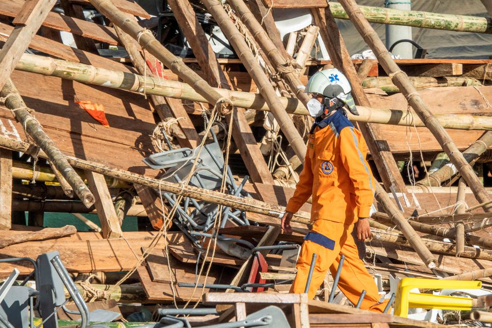 A Colombian Civil Defense worker walks amidst the rubble of some stands that collapsed in a bullring during the celebrations of the San Pedro festivities, in El Espinal, Colombia June 26, 2022. Photo: Reuters