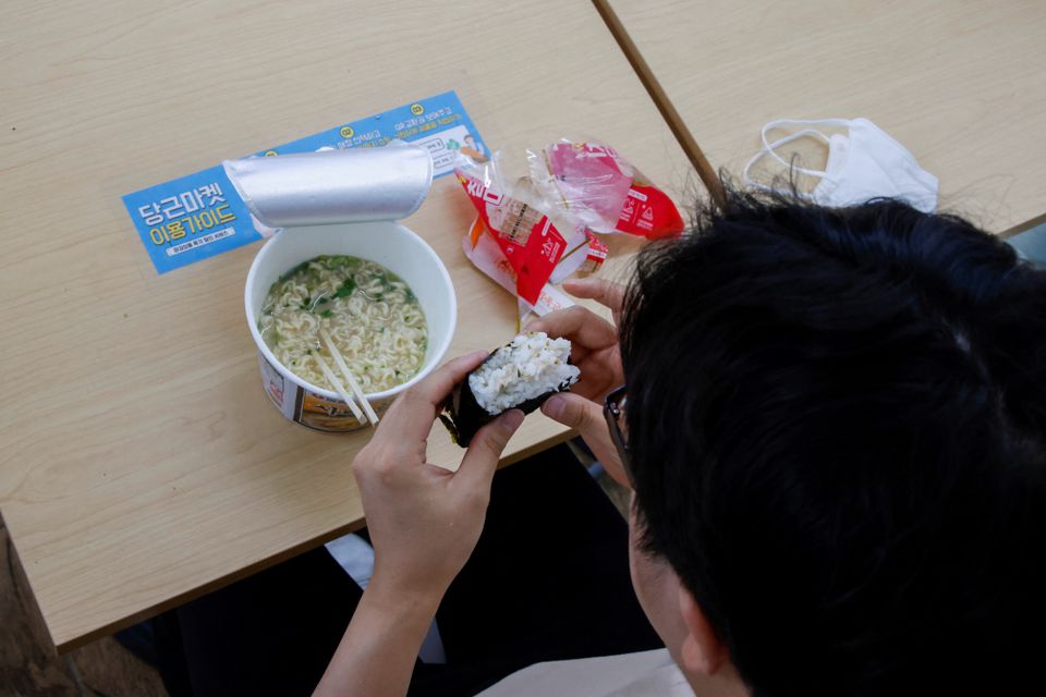An office worker eats his lunch at a convenience store in Seoul, South Korea, June 24, 2022. Photo: Reuters