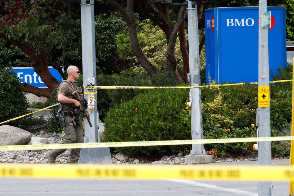 A police officer looks on after two armed men entering a bank were killed in a shootout with the police in Saanich, British Columbia, Canada June 28, 2022. Photo: Reuters