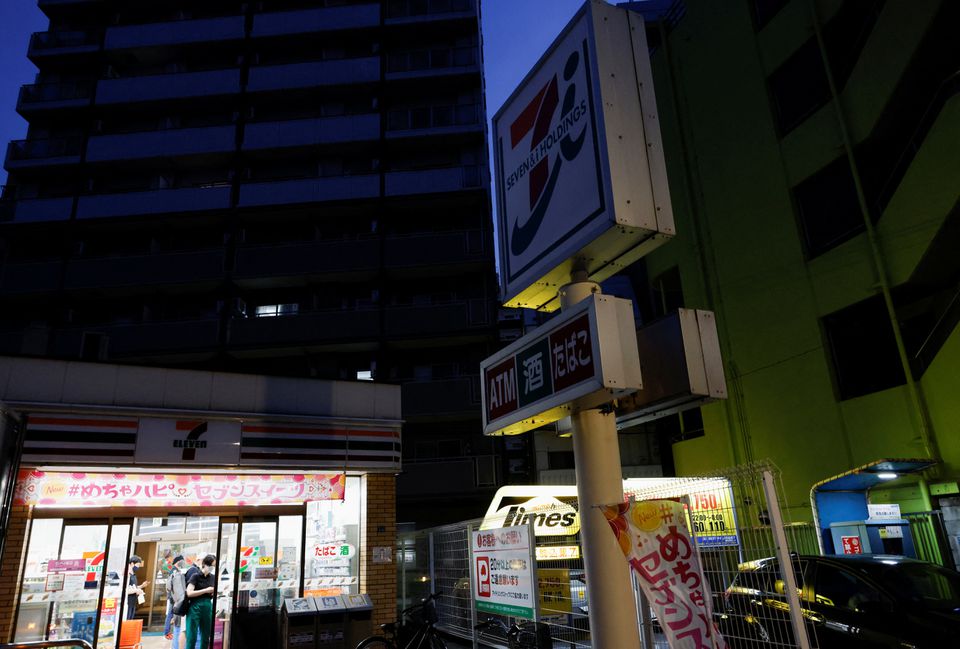 The signboards of a 7-Eleven store, operated by Seven & i Holdings, are partially switched off to take power-saving measures as Japanese government issues warning over possible power crunch due to heatwave in Tokyo, Japan June 29, 2022. Photo: Reuters