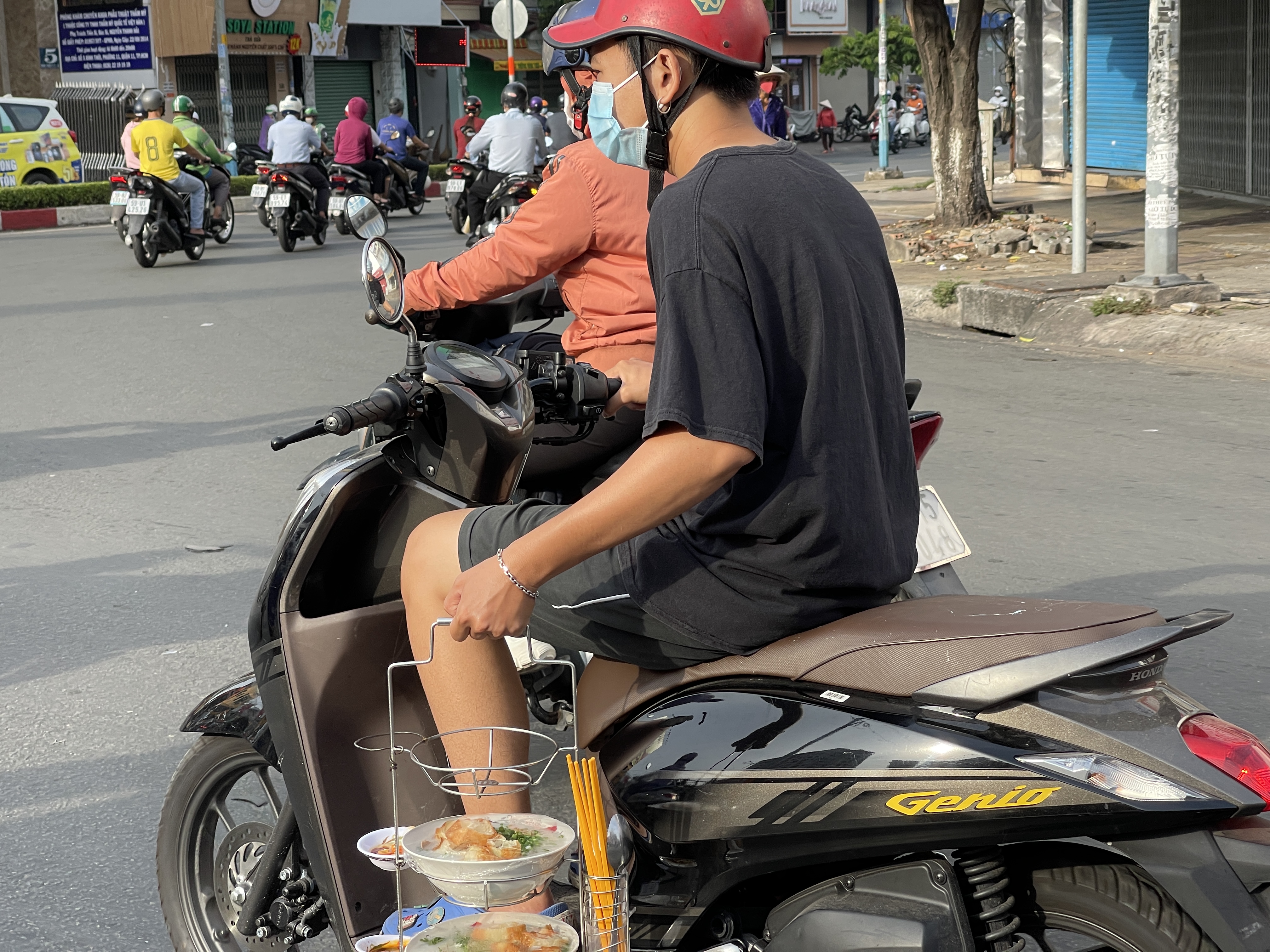 Only in Vietnam: a man delivers bowls of congee by motorbike on the street of Ho Chi Minh City. Photo: Dong Nguyen / Tuoi Tre News