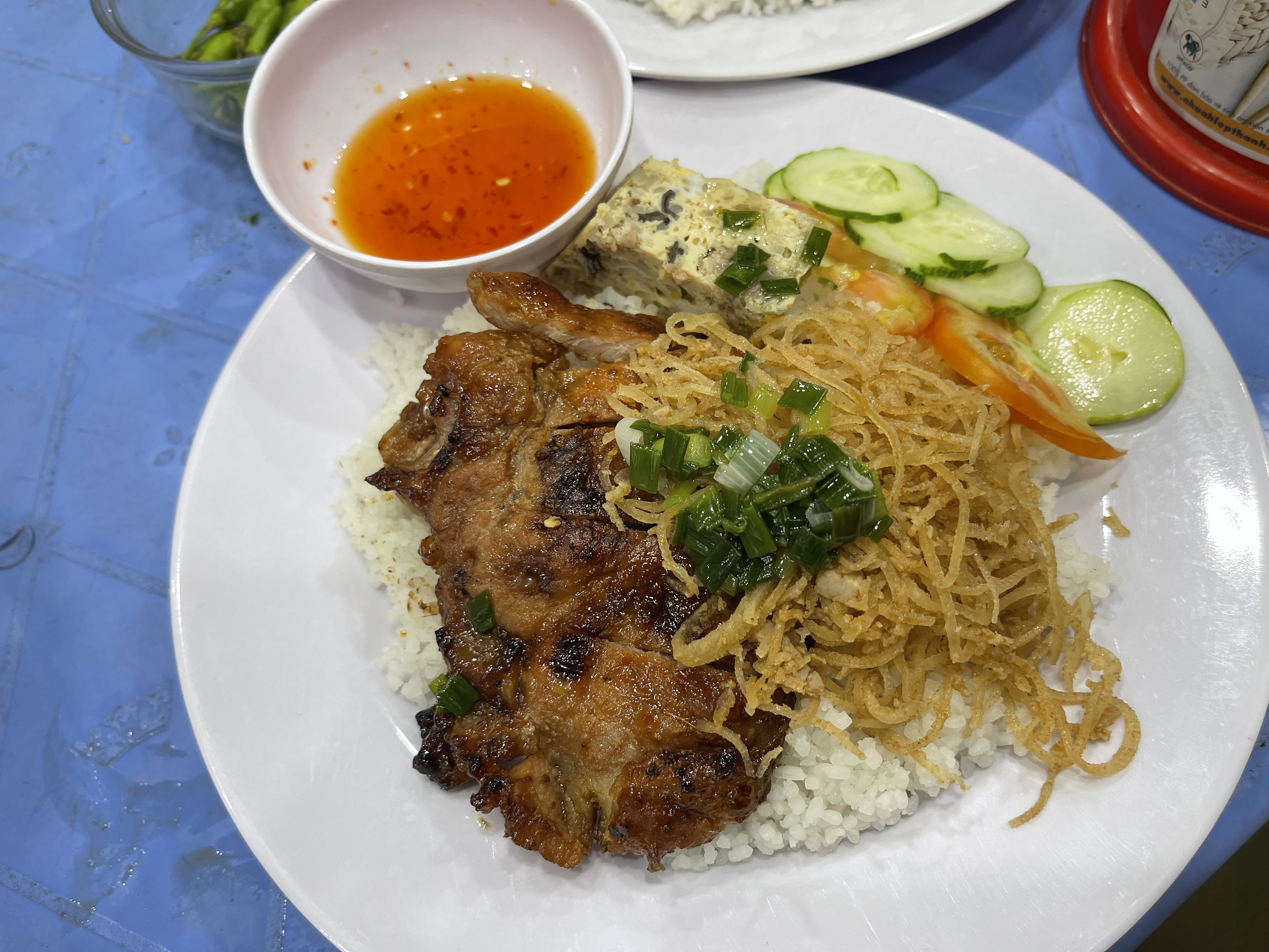 A dish of 'com tam' (broken rice topped with grilled ribs and shredded pork skin) is served at a local 'quán' (food stall) in District 12, Ho Chi Minh City. Photo: Dong Nguyen / Tuoi Tre News