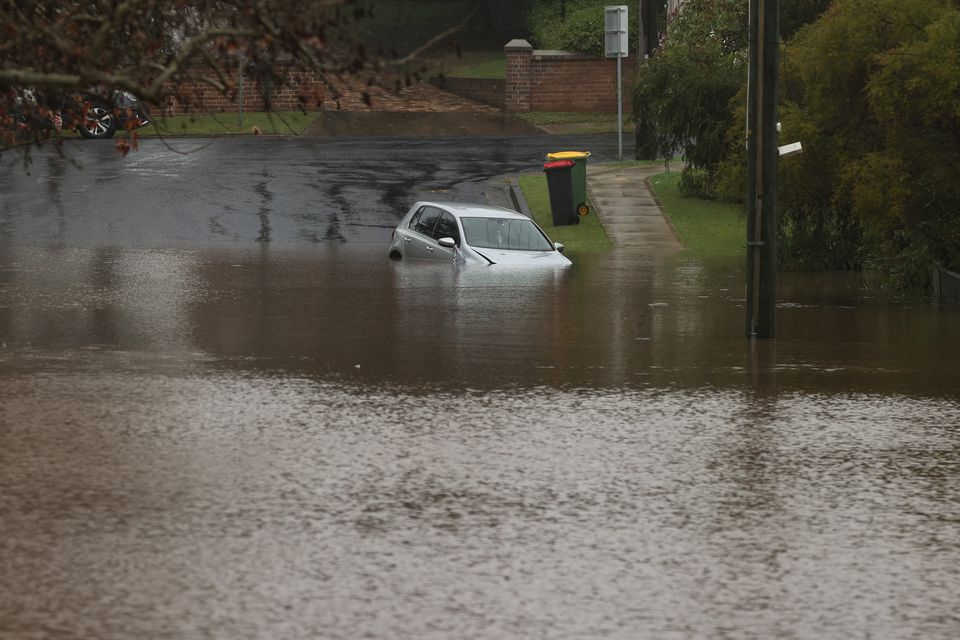 A vehicle is submerged by floodwaters in a residential area following heavy rains in the Windsor suburb of Sydney, Australia, July 5, 2022. Photo: Reuters