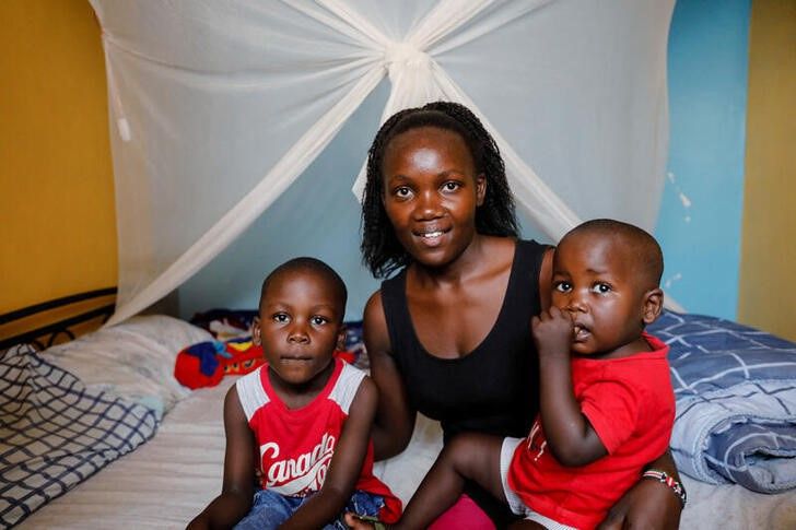 Rebecca Adhiamba Kwanya, 29, poses for a photo with her sons Betrun, 4, and 18-month-old Bradley, at their home in Kisumu, Kenya, July 1, 2022. Photo: Reuters