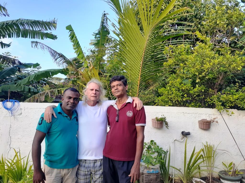 Stivi Cooke (C) poses for a photo with Karum (R) and tuk-tuk driver Sujee in Sri Lanka.